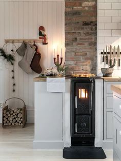 a stove sitting in the middle of a kitchen next to a counter with candles on it