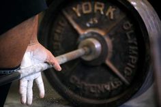 a man is holding a barbell in his hand