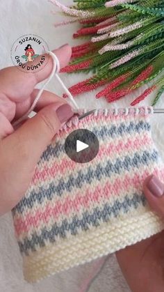 someone is knitting a small bag with yarn