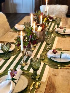 the table is set with candles and plates