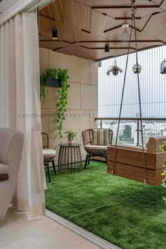 an outdoor living area with green grass and hanging chairs, potted plants on the balcony