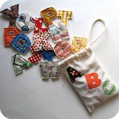 a white bag filled with lots of different types of fabric items on top of a table