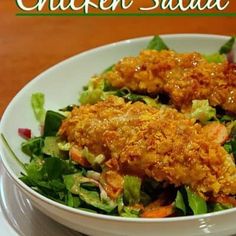 a white bowl filled with chicken salad on top of a table