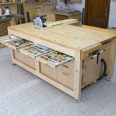 a workbench with drawers and tools in it