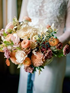 a bride holding a bouquet of flowers in her hand