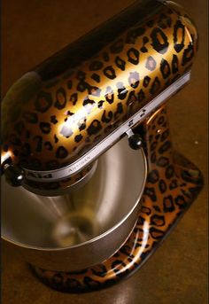 an animal print mixer on top of a metal bowl