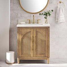 a bathroom vanity with a round mirror above it and a white rug on the floor