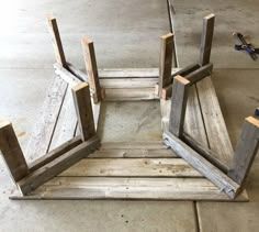 three pieces of wood sitting on top of each other in the middle of a floor