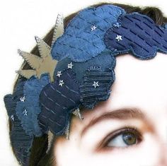 a close up of a person wearing a blue headband with stars and leaves on it