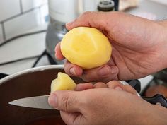 a person is peeling a piece of butter into small pieces