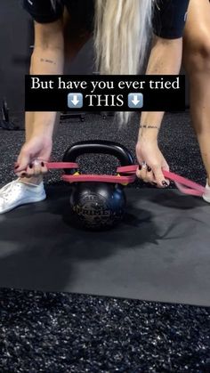 a woman is doing exercises with a kettle