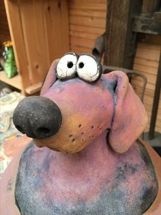 a dog statue with googly eyes on it's head