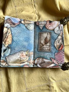 an open book with shells and sea animals on it