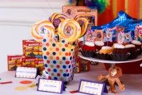 a table topped with lots of cupcakes and candy