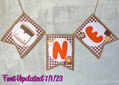 two bunting banners with pictures of food on them hanging from the wall next to each other