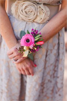 a woman in a dress holding a bouquet of flowers with her hands on her hip