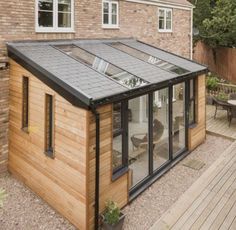 a small wooden house with a glass roof