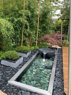 an outdoor garden with rocks and water features