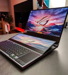 an open laptop computer sitting on top of a table