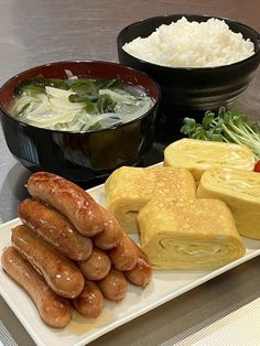 there are many different types of food on the plate and in bowls next to each other