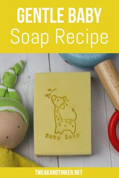 a baby soap recipe on a table next to a wooden spoon and rubber stamp with an image of a giraffe