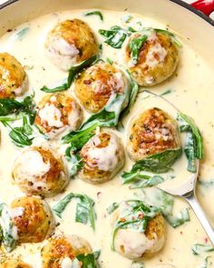 a pan filled with spinach and cheese covered meatballs