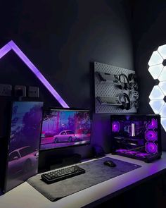 three computer monitors sitting on top of a desk next to a keyboard and monitor screen