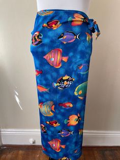 Vintage wrap swimsuit material coverup skirt. Blue with colorful fish design, polyester spandex blend. Marked size XL.  Please ask questions!  Measurements (laid flat):  Tag Size: XL Length: 35" Waist: 17"x2 Hips: 18"x2 Condition: Great vintage condition, no issues noted.  The vintage pieces I sell have all led a previous life and may tell their stories through minor imperfections. I'll do my best to indicate overall condition, but please refer to the pictures. Your purchase continues the life o Fish Skirt, Wrap Swimsuit, Skirt Coverup, Vintage Swim, Swimsuit Material, Fish Pattern, Coverup Skirt, Blue Fish, Fish Patterns