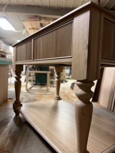 a close up of a wooden table in a room with wood flooring and furniture