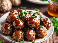 meatballs covered in sauce and parsley on a white plate next to some mushrooms