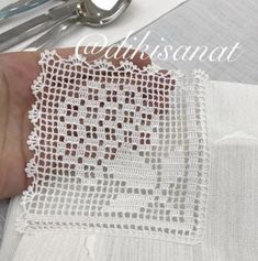 someone is stitching together some white fabric