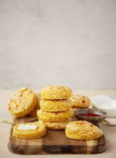 a stack of biscuits sitting on top of a wooden cutting board