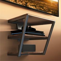 a wall mounted shelf with a television on it