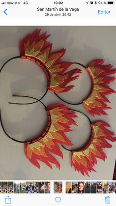 a pair of red and gold headbands sitting on top of a white table