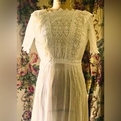 I Love It When I Come Across These Antique Cotton Dresses In Great Condition. This One Is Absolutely Beautiful Very Intricate Lace And Rodri At The Bottom. The Bottoms Is Also Beautiful Drawn Lace And Embroidery Work. The Sleeves Are Also Pleated And Finished With Lace. The Dress Is On A Size 10 Mannequin And I Could Not Close The Back So It Is Probably About A Size 6 -The Antique Sizes Are All Just Approximate.The Sleeve Length Is 10 Inches.The Waist Side To Side, Lying Flat, Is Only 10 Inches White Fitted Empire Waist Dress, Fitted Maxi Dress With Lace Patchwork And Short Sleeves, Fitted Short Sleeve Maxi Dress With Lace Patchwork, White Fitted Vintage Dress, Fitted Lace Work Dresses, White Lace Maxi Dress For Daywear, Fitted Maxi Dress With Lace Patchwork For Daywear, Short Sleeve Dresses With Lace Patchwork For Daywear, Fitted Short Sleeve Maxi Dress With Lace Trim