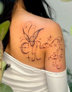 a woman with a butterfly tattoo on her shoulder