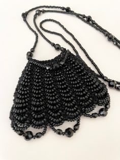 "A beautiful black knitted bag made by me with black Czech seed beads and all black accent beads. The bag feels wonderfully soft to touch. These are all good quality beads. No plastic!! The necklace strap measures 28\" The bag measures approx. 2 1/4\" x 2 3/4\"" Black Beaded Bags As Fashion Accessory, Black Beaded Bag As Fashion Accessory, Black Beaded Chain Necklaces For Evening, Evening Black Beaded Necklaces, Black Handmade Beaded Necklaces For Evening, Elegant Black Necklace For Everyday Use, Black Beaded Bags, Black Beaded Bag, Amulet Bag