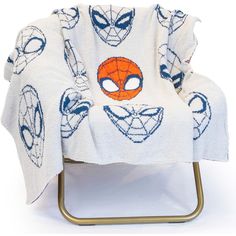 a spiderman towel sitting on top of a chair with eyes and head drawn on it