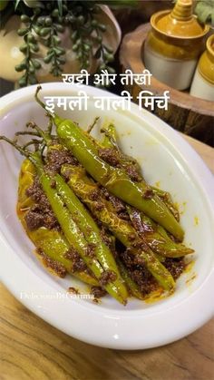 some green peppers in a white bowl on a wooden table with words written in the middle