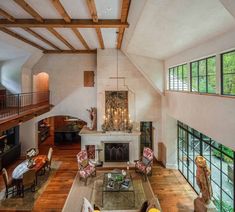 a large living room filled with furniture and a fire place in the middle of it