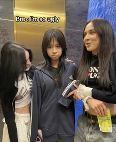 three young women standing next to each other in front of a blue wall with the words bro i'm so ugly