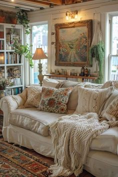 a living room filled with lots of furniture and decor on top of a wooden floor