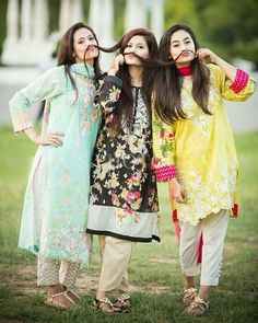 three young women standing next to each other