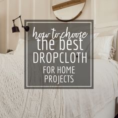 a bedroom with white bedding and a round mirror above it that says, how to choose the best dropcloth for home projects