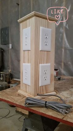 a wooden box with two electrical outlets attached to it