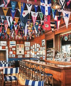 a bar with many flags hanging from the ceiling