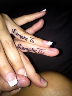 two people with their hands in the shape of fingers that have writing on each finger