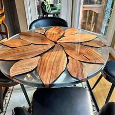 a glass table with wooden flowers on it