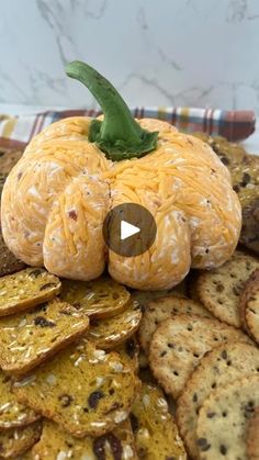 an orange sitting on top of some crackers