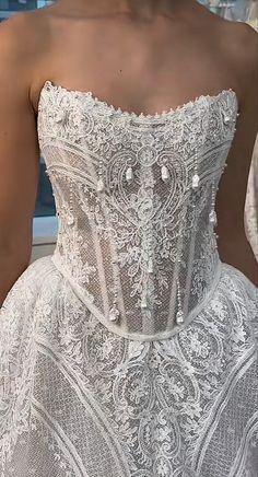 the back of a wedding dress with beading on it